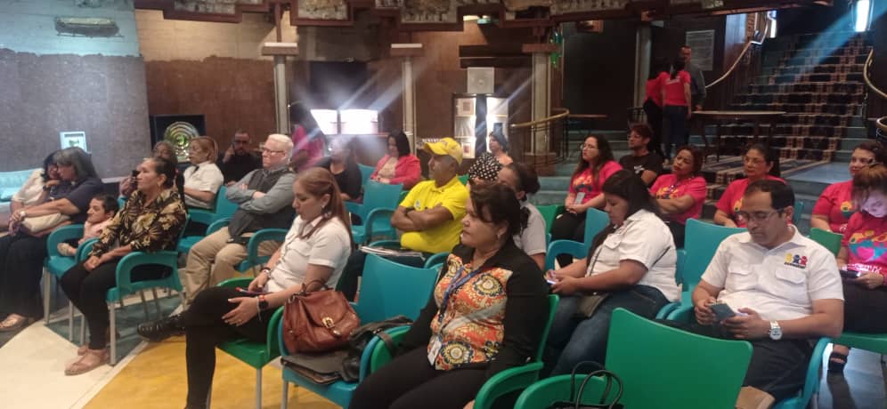 people holding umbrellas on a busy street at night lit by street lights and illuminated signs in Tokyo, Japan